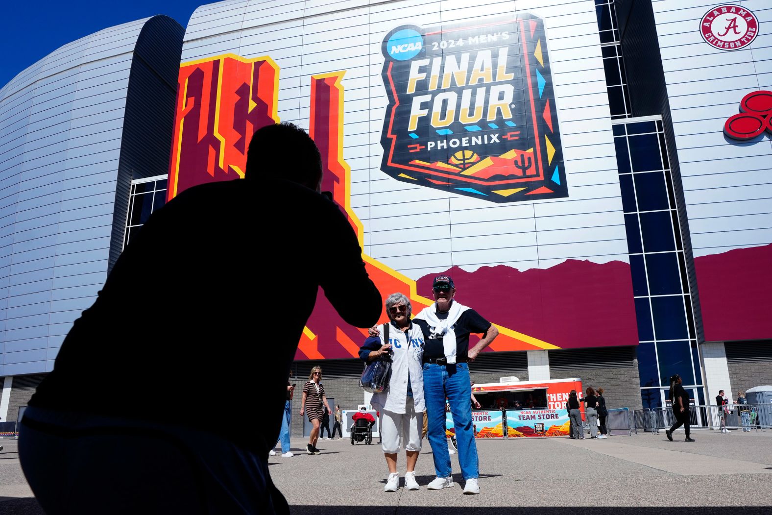 Fans pose for photos outside State Farm Stadium prior to the game.