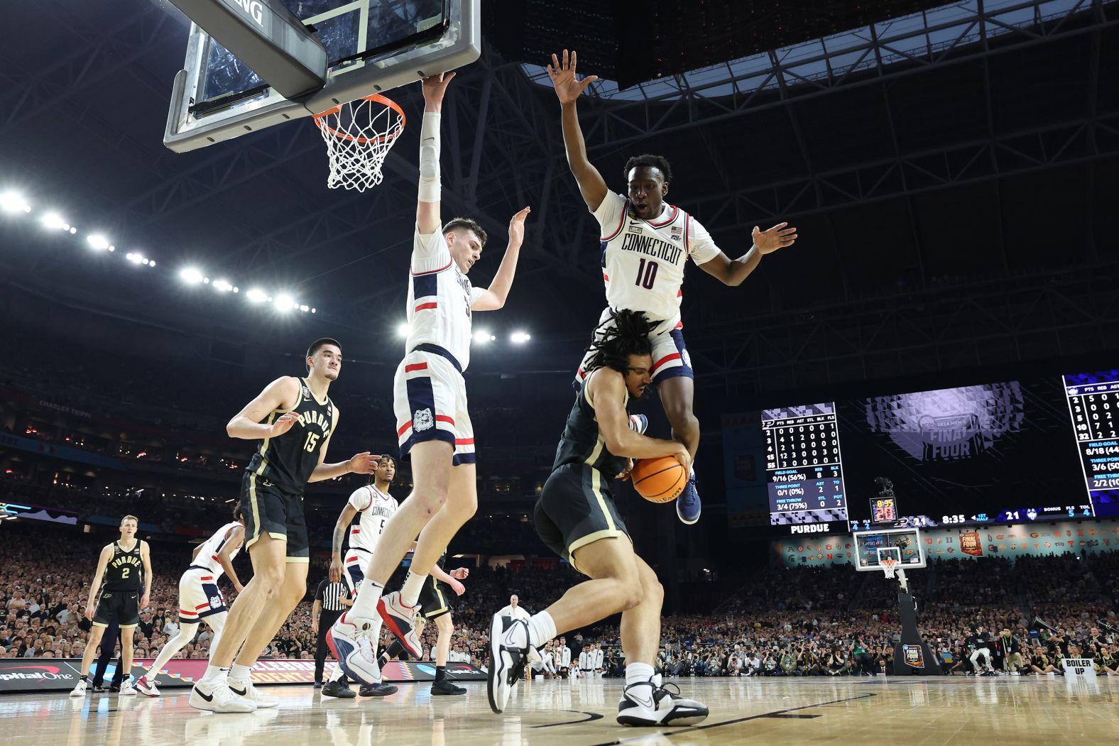 UConn's Hassan Diarra leaps above Purdue's Trey Kaufman-Renn.