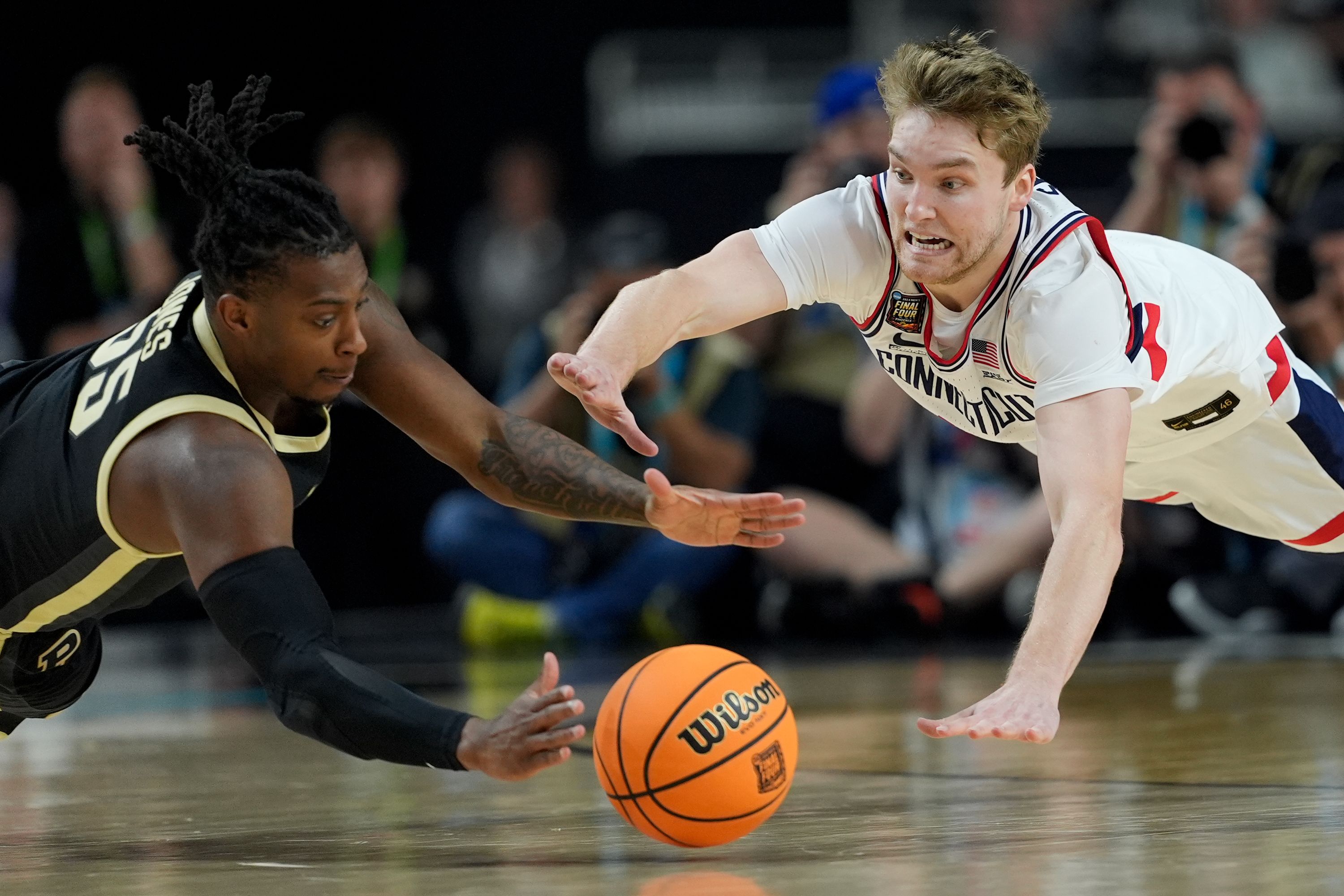 Purdue's Lance Jones vies for the ball with UConn's Cam Spencer during the second half.