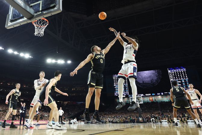 UConn's Stephon Castle attempts a shot while being guarded by Purdue's Mason Gillis.