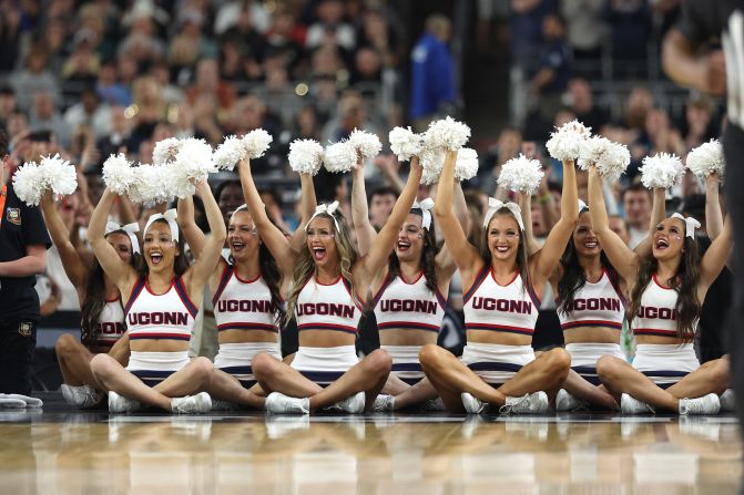 UConn cheerleaders root for their team during game.
