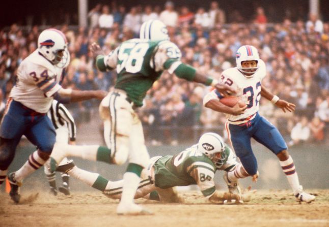 Simpson carries the ball against the New York Jets in 1973. During that season, he broke the single season NFL rushing record with a total of 2,003 yards.