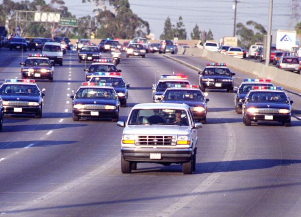Al Cowlings drives a white Ford Bronco with Simpson inside as California police officers chase the pair on the 91 Freeway on June 17, 1994. Five days prior, Simpson's ex-wife Nicole Brown Simpson and Ronald Lyle Goldman were found stabbed to death. Simpson was questioned the next day and then charged with two counts of murder with special circumstances. He did not surrender and was declared a fugitive. A suicide letter was found shortly before Simpson was discovered to be riding in Cowlings' car.