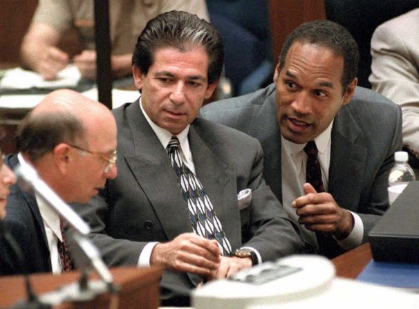 Simpson consults with Robert Kardashian, center, and Alvin Michelson, left, during a hearing about Kardashian taking the witness stand in Simpson's murder trial in May 1995.