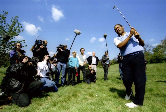 Simpson is surrounded by the media as he plays a round of golf in Surrey, England, in May 1996.