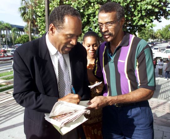 Simpson signs autographs outside a Dade County courthouse in Miami in 2001.