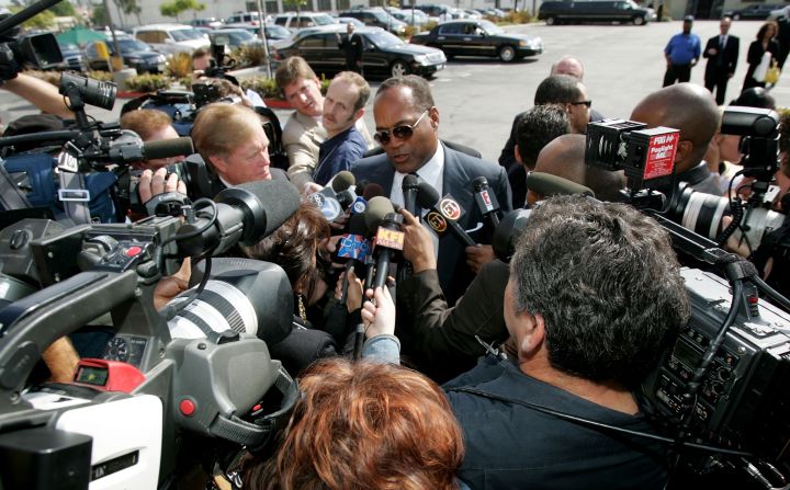 Simpson is swarmed by the media in 2005 as he arrives for the funeral of lawyer Johnnie Cochran, Jr., who represented Simpson in his murder trial.