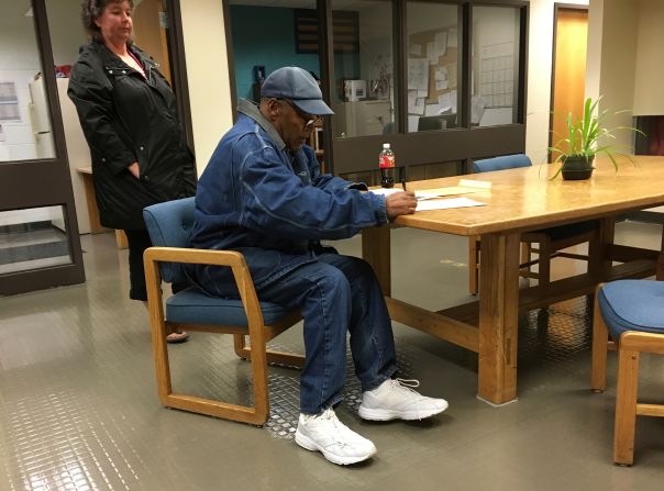 Simpson signs documents at the Lovelock Correctional Center in Nevada in September 2017, before being released.