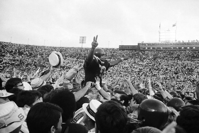 Simpson is carried off the field by hundreds of cheering USC fans after the team defeated UCLA in November 1967.