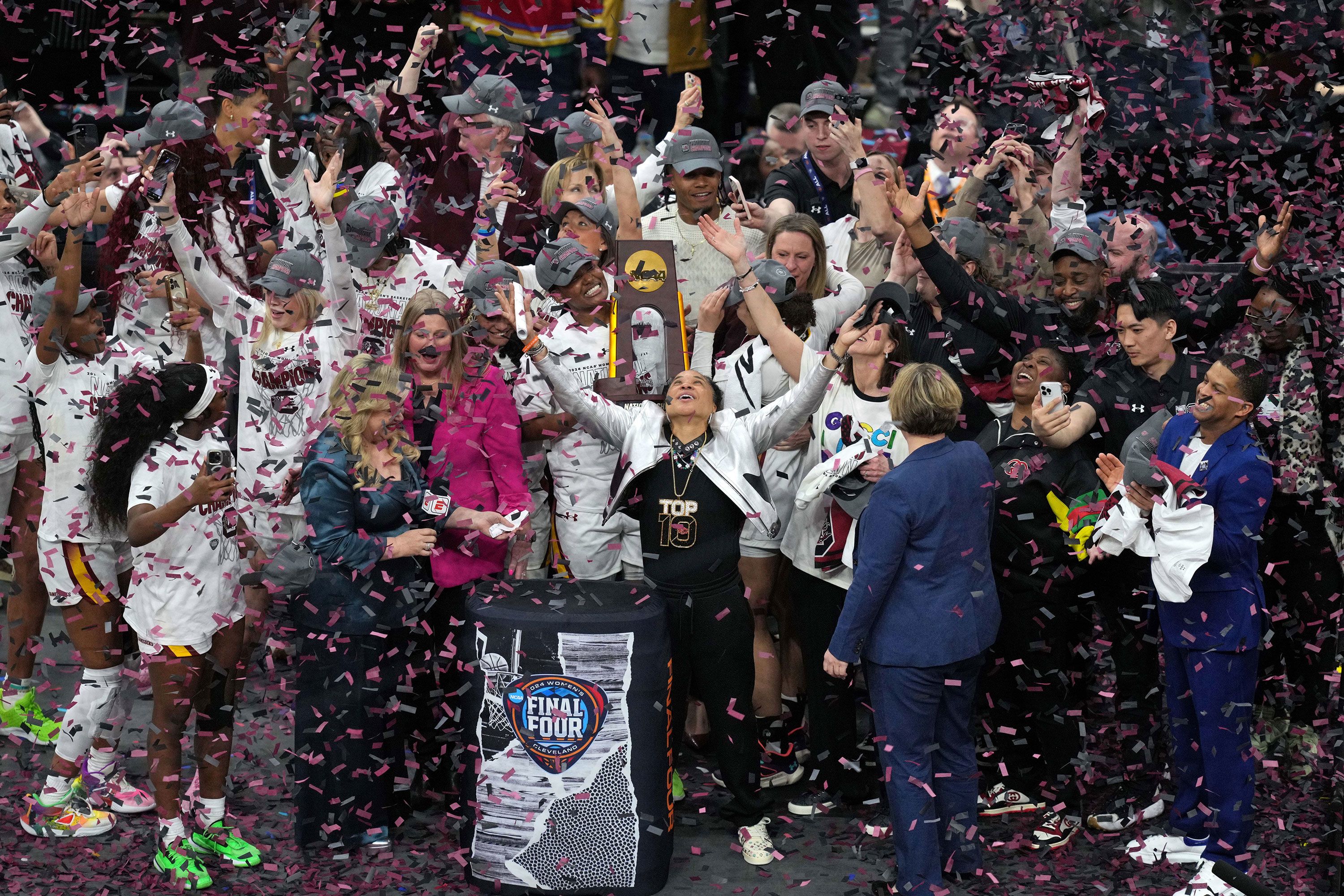 Head coach Dawn Staley, center, and the South Carolina Gamecocks celebrate after beating the Iowa Hawkeyes in the NCAA women's basketball national championship in Cleveland on Sunday, April 7.