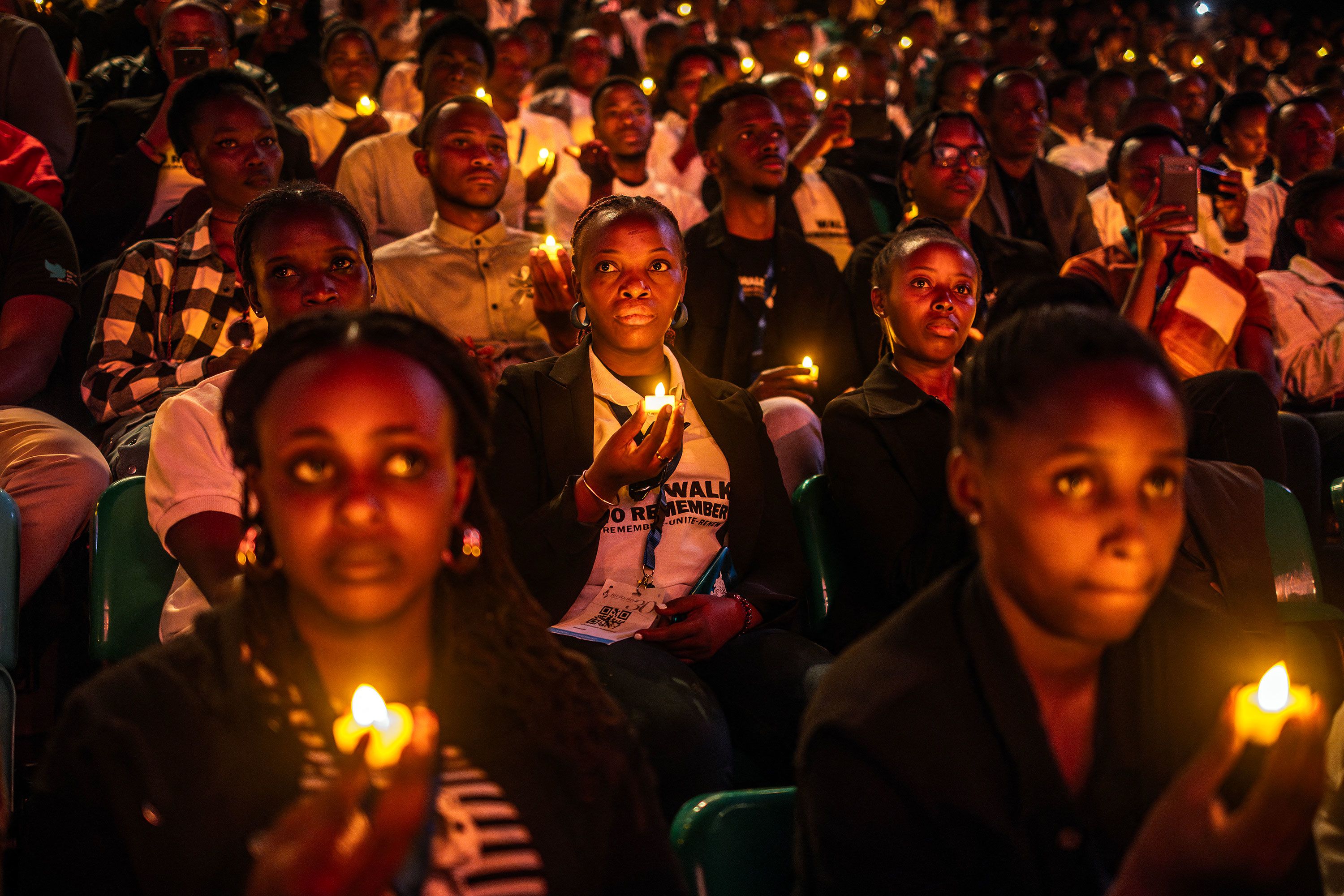 Young Rwandans hold flameless candles during a vigil commemorating the 30th Anniversary of the 1994 Rwandan genocide in Kigali on Sunday, April 7.