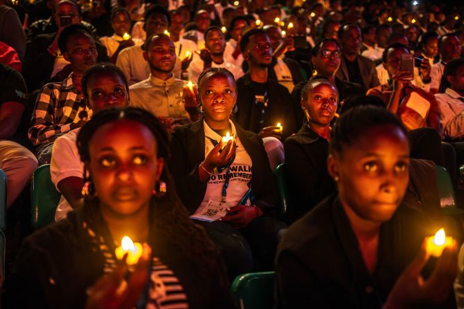 Young Rwandans hold flameless candles during a vigil commemorating the 30th Anniversary of the 1994 Rwandan genocide in Kigali on Sunday, April 7.