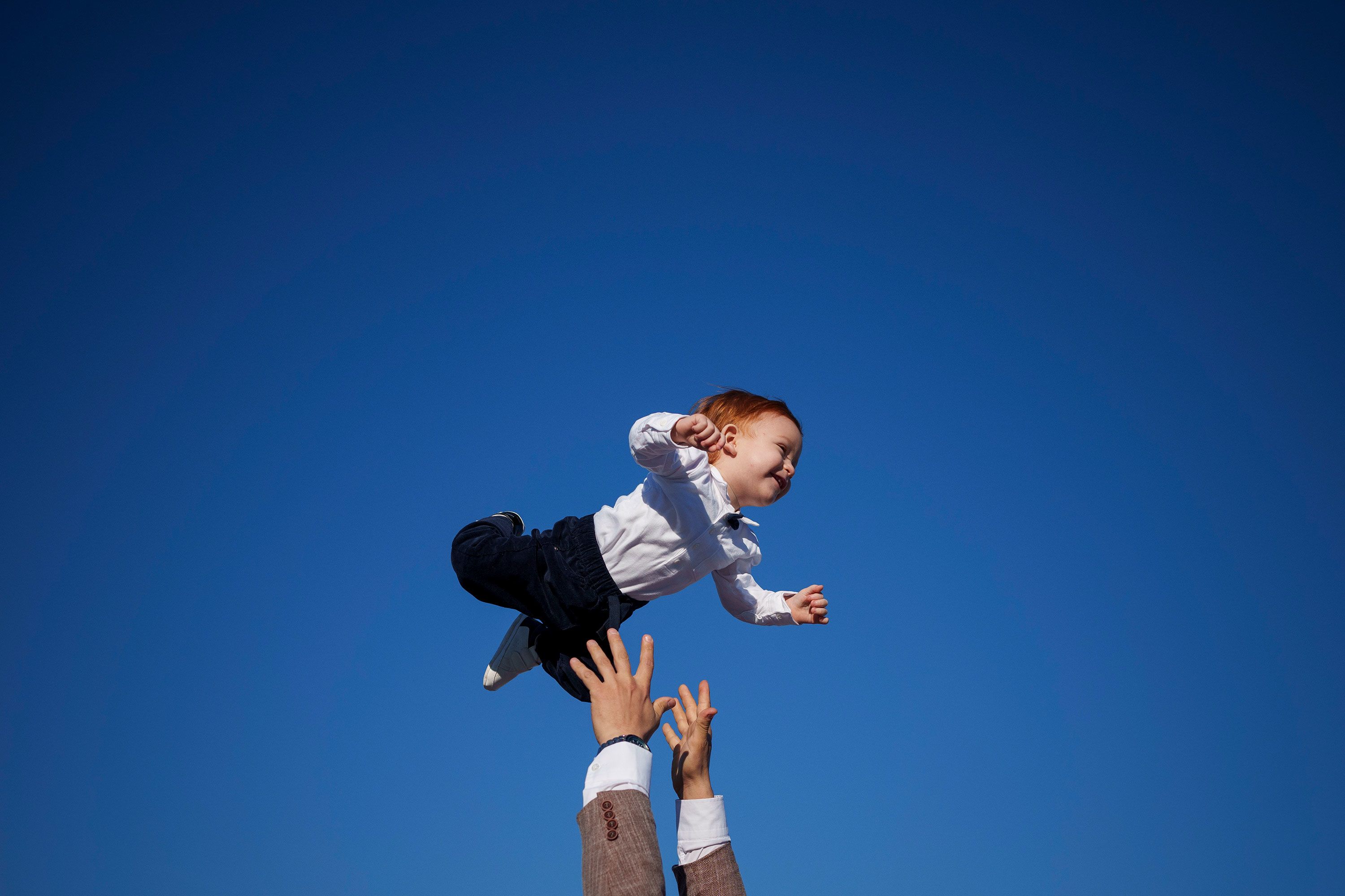 A Muslim man playfully throws a child into the air at the end of Eid al-Fitr prayers in Bucharest, Romania, on Wednesday, April 10.