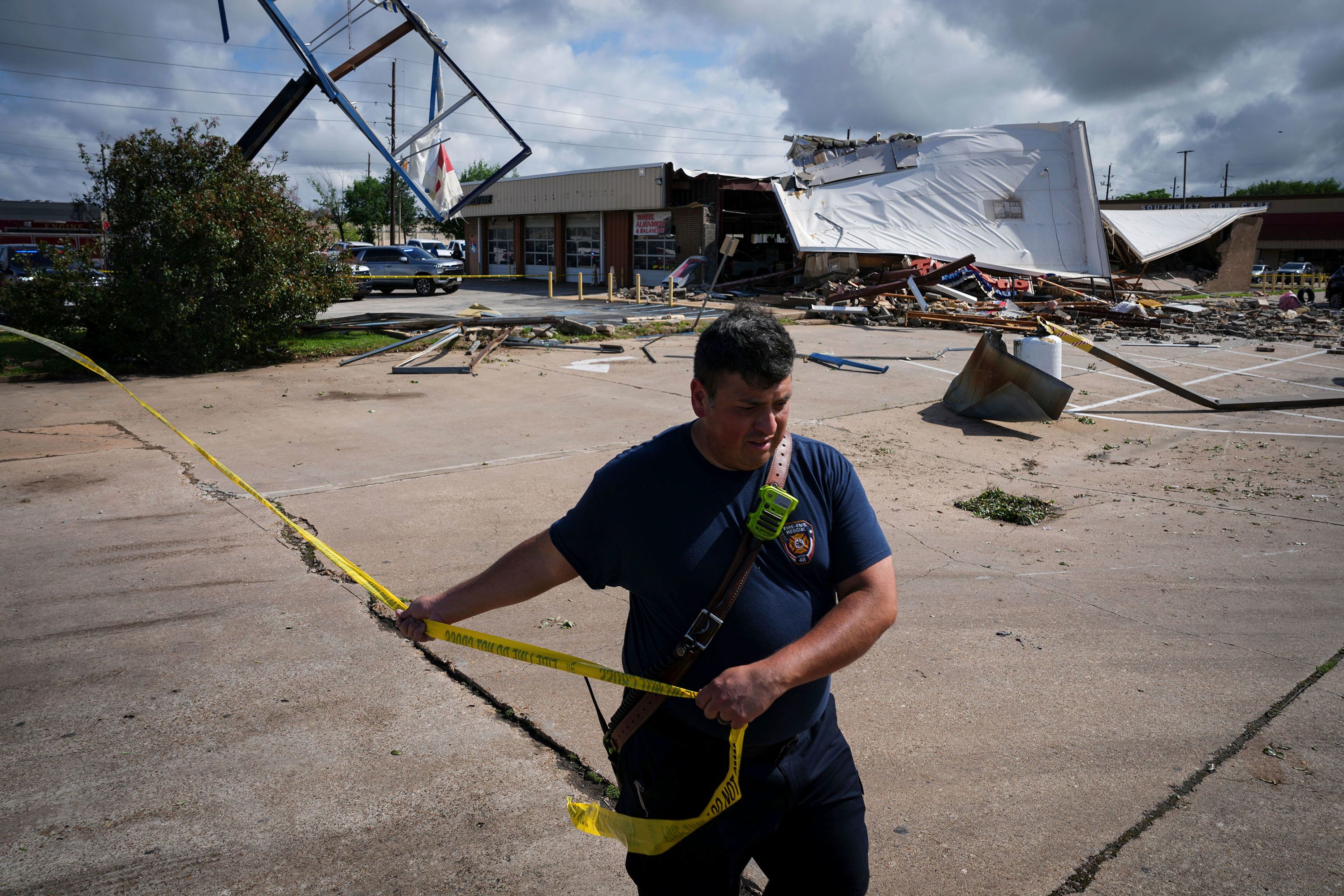 Firefighter Jeremy Perez works the scene where a tornado damaged several businesses in Katy, Texas, on Wednesday, April 10.