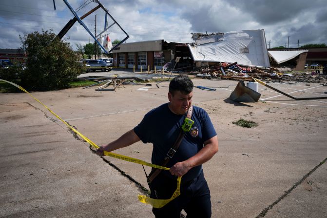 Firefighter Jeremy Perez works the scene where a tornado damaged several businesses in Katy, Texas, on Wednesday, April 10. Dangerous storms moved through parts of the southeast this week, <a href="https://www.cnn.com/us/live-news/severe-storms-texas-south-04-10-24/index.html" target="_blank">spawning tornadoes and flash flood emergencies</a>.