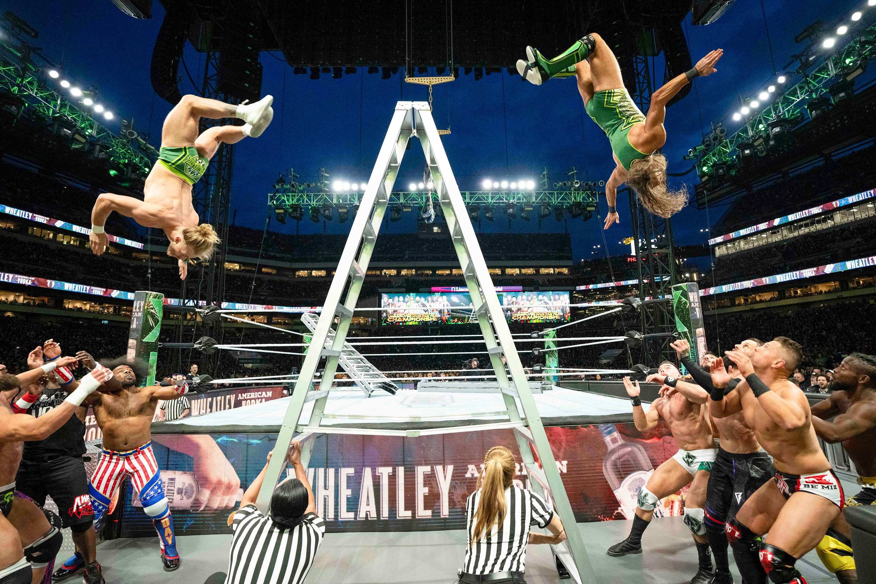 Tyler Bate and Pete Dunne fly off a ladder during a match at WWE WrestleMania 40 in Philadelphia on Saturday, April 6.