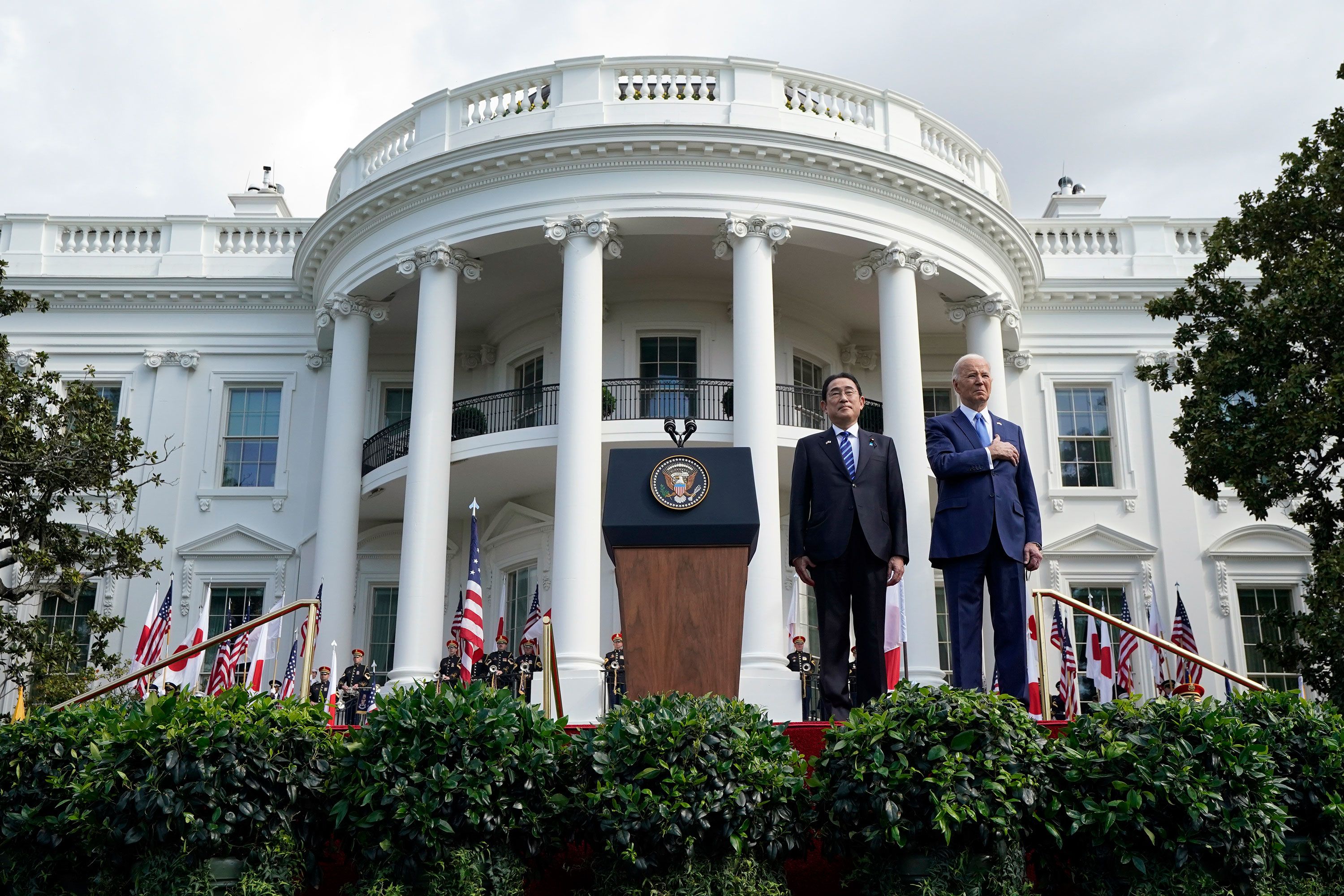 President Joe Biden and Japanese Prime Minister Fumio Kishida listen to the National Anthem during a ceremony on the South Lawn of the White House in Washington, DC, on Wednesday, April 10.