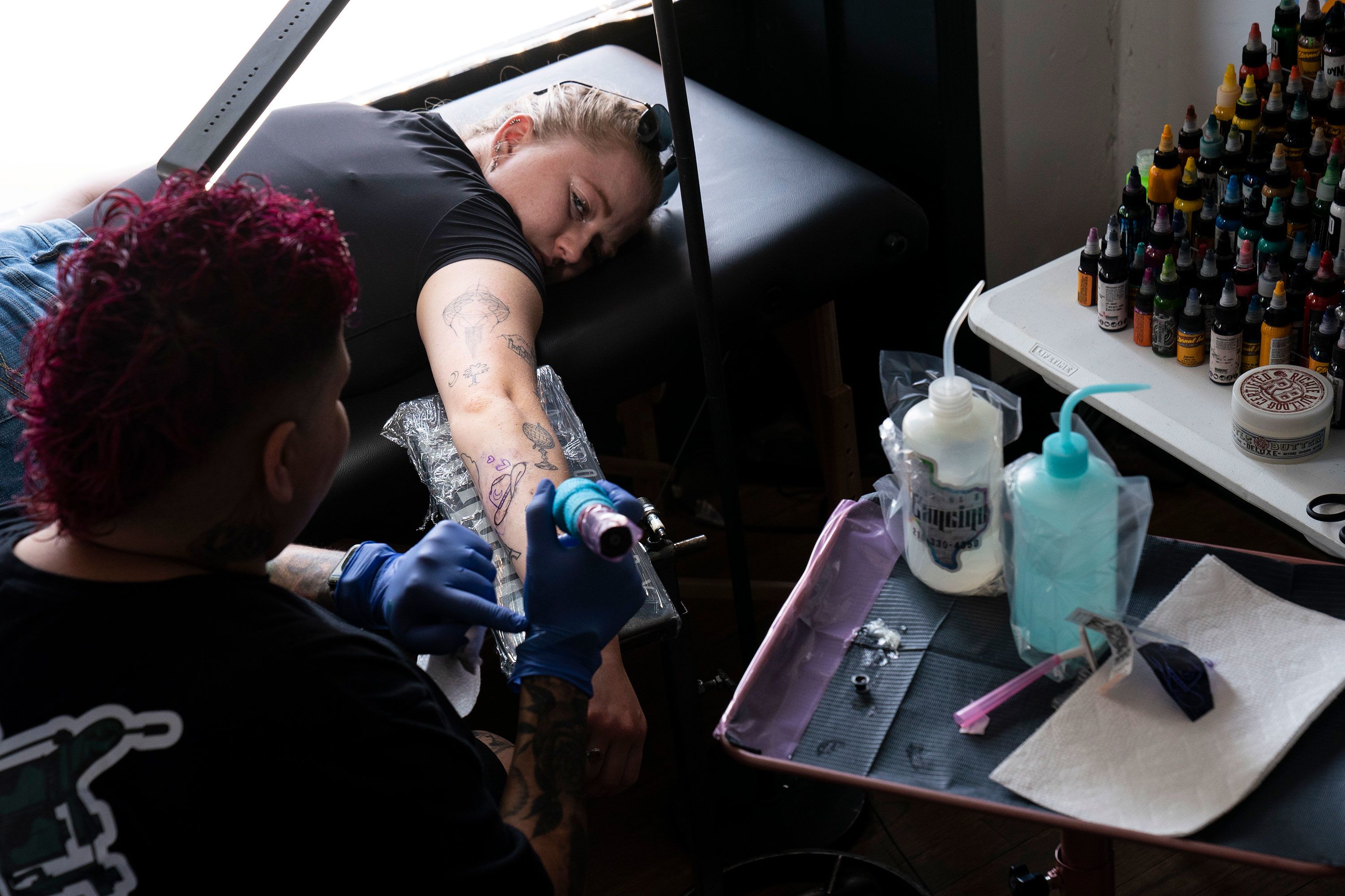 Gwen Rychlik gets a tattoo of a moon and cowboy hat at a popup tattoo parlor in Del Rio, Texas, on Saturday, April 6.