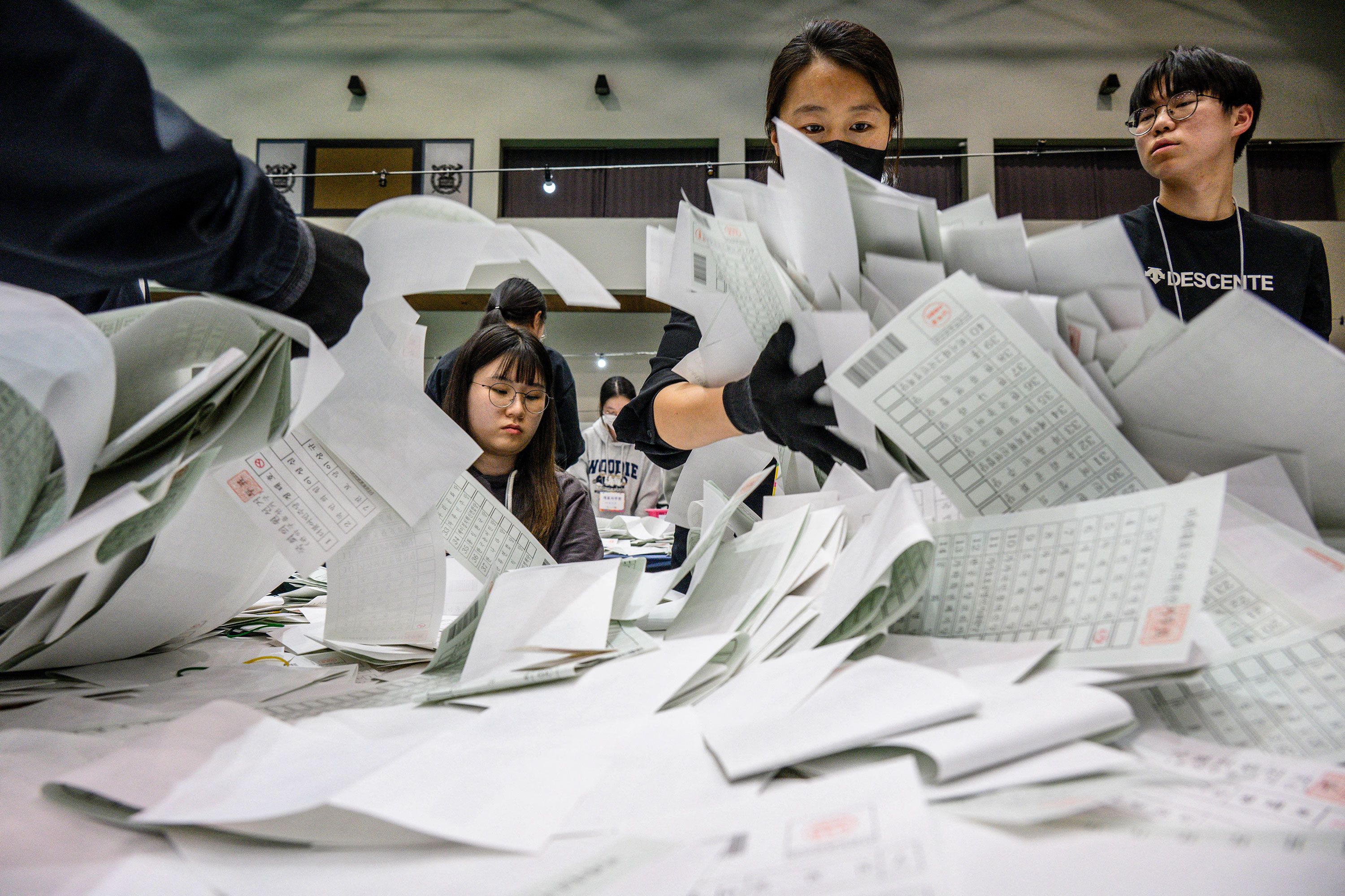 Election officials sort through ballots at a counting station in Seoul, South Korea, after voting closed on Wednesday, April 10.