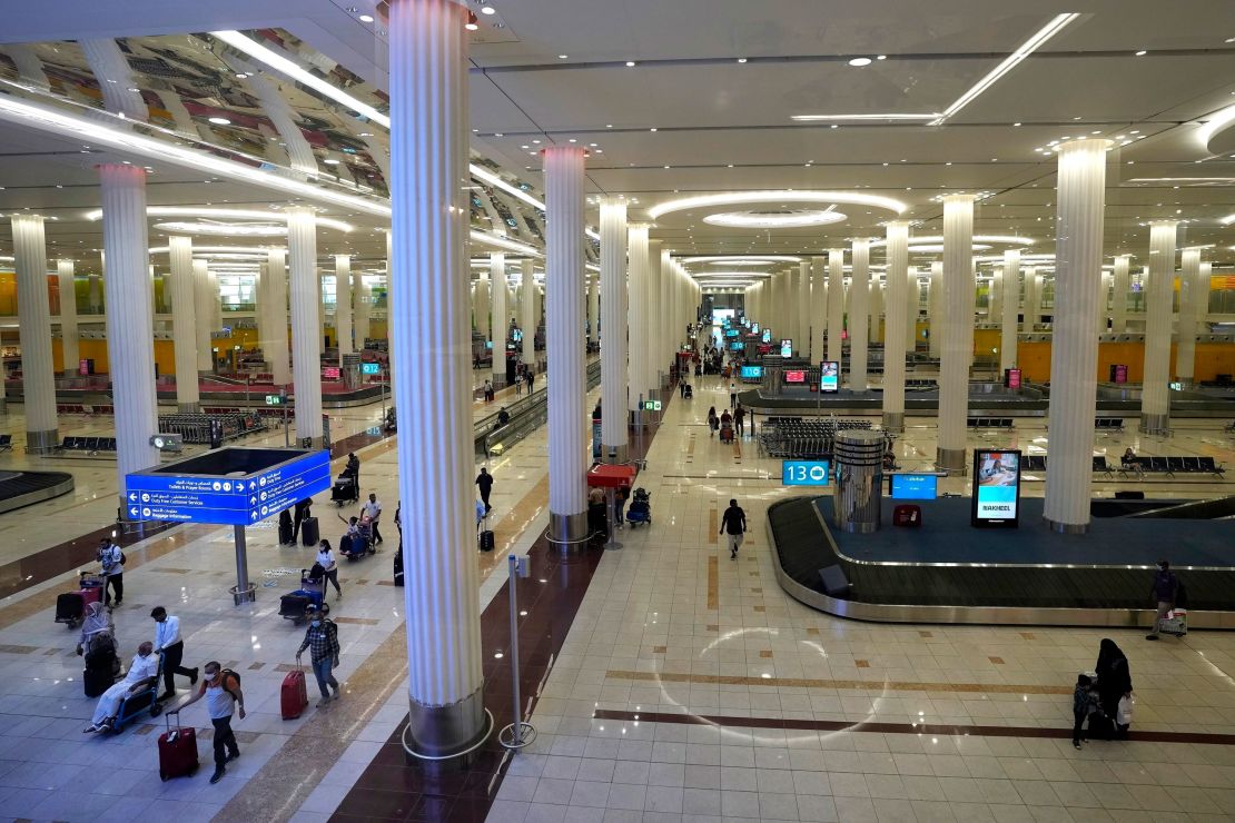 Passengers leave the baggage handling hall at the Dubai International Airport terminal 3, in Dubai, United Arab Emirates, on Oct. 25, 2022.