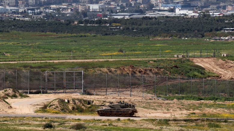 This picture taken from Israel's southern border with the Gaza Strip shows an Israeli army tank moving along the border with the Palestinian territory on March 20, 2024, amid the ongoing conflict between Israel and the militant group Hamas.