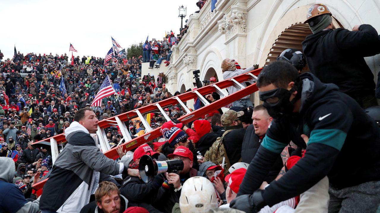 Pro-Trump protesters storm into the US Capitol during clashes with police, during a rally to contest the certification of the 2020 US presidential election results by the US Congress, in Washington, DC, on January 6, 2021.