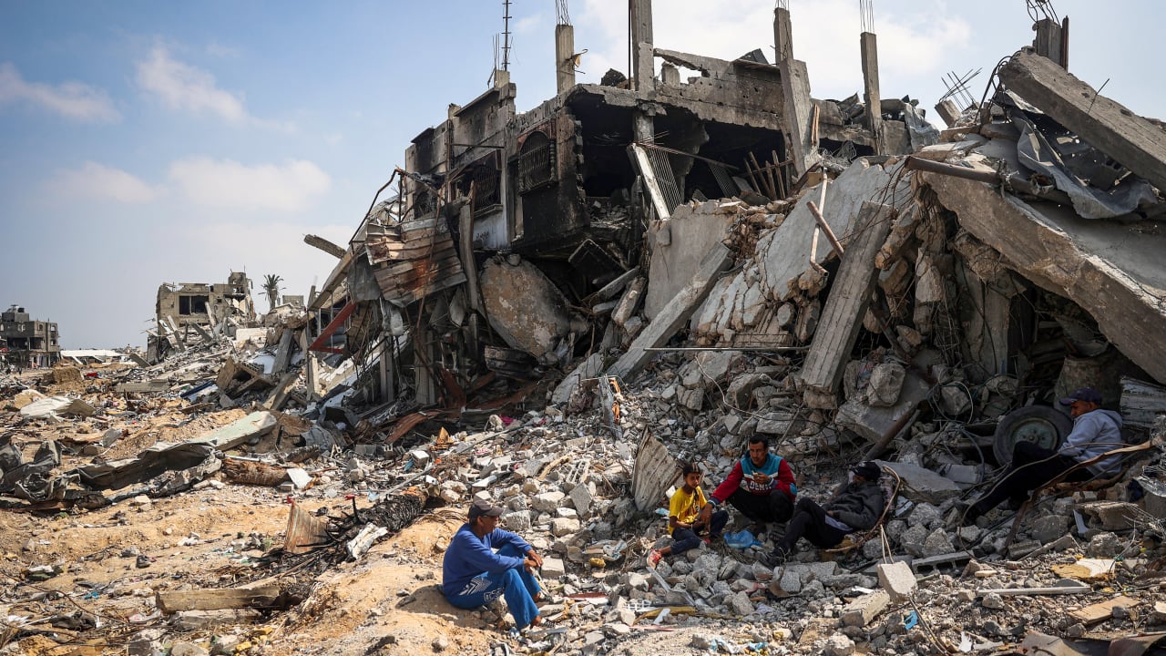 TOPSHOT - People sit on the rubble of buildings destroyed during Israeli bombardment in Khan Younis, on the southern Gaza Strip on April 16, 2024, as fighting continues between Israel and the Palestinian militant group Hamas. (Photo by AFP) (Photo by -/AFP via Getty Images)