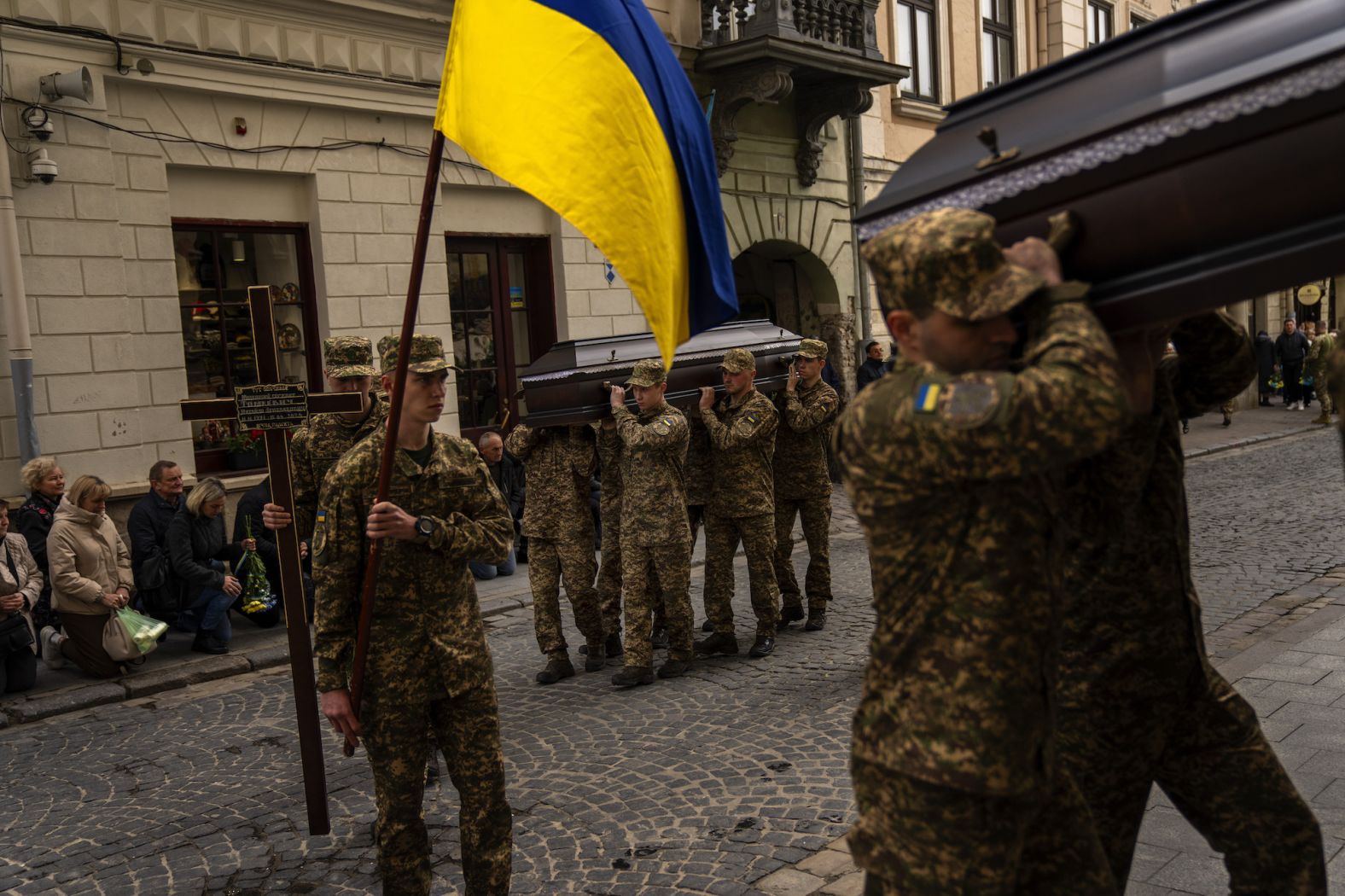 Soldiers carry the coffins of Ukrainian army sergeants Tomkevych Mykhailo and Kril Olexander during their funeral at the Saints Peter and Paul church in Lviv, Ukraine, on Tuesday, April 16.