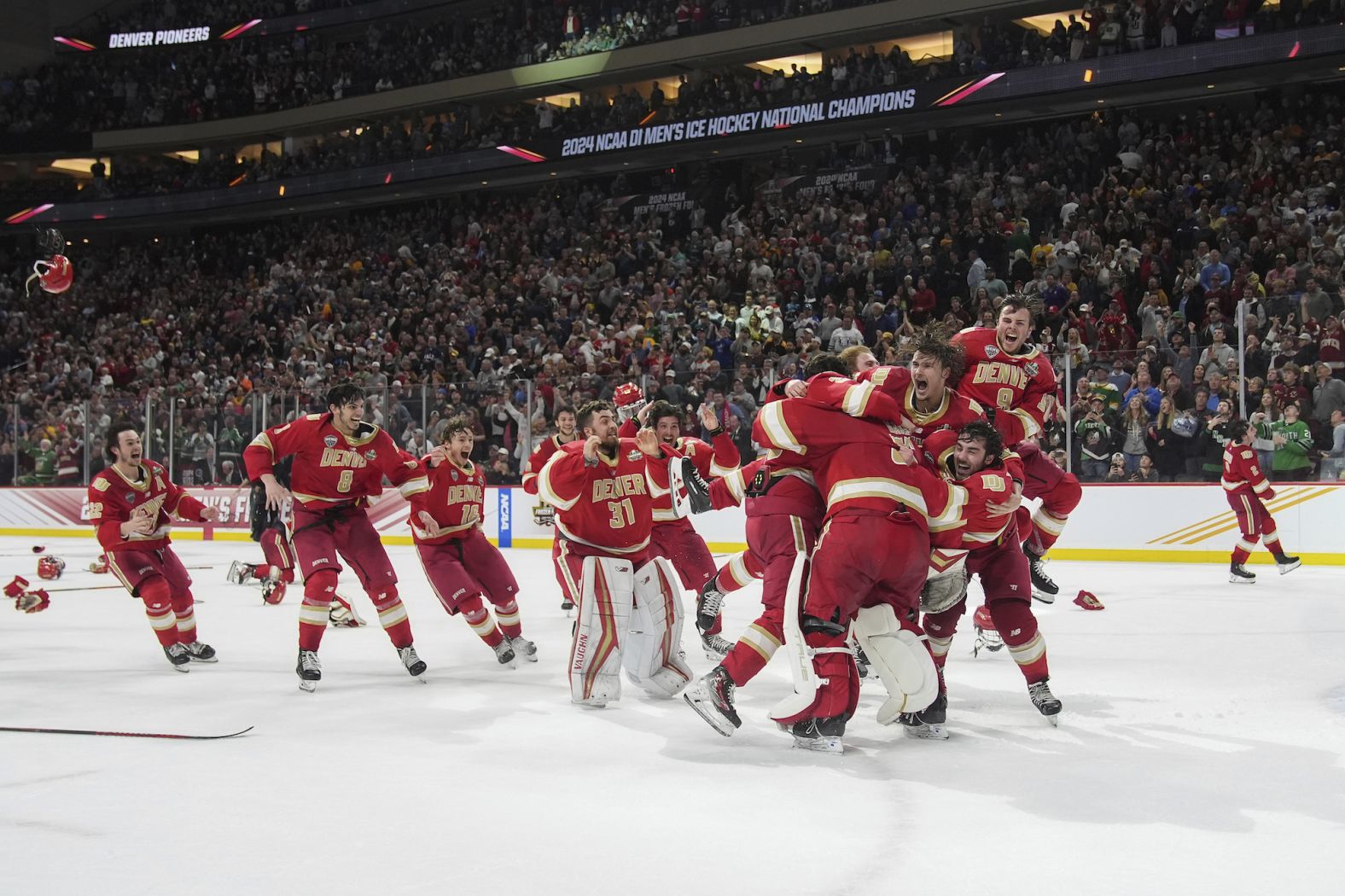 Denver celebrates after defeating Boston College in the championship game of the men's NCAA college hockey tournament in St. Paul, Minnesota, on Saturday, April 13.
