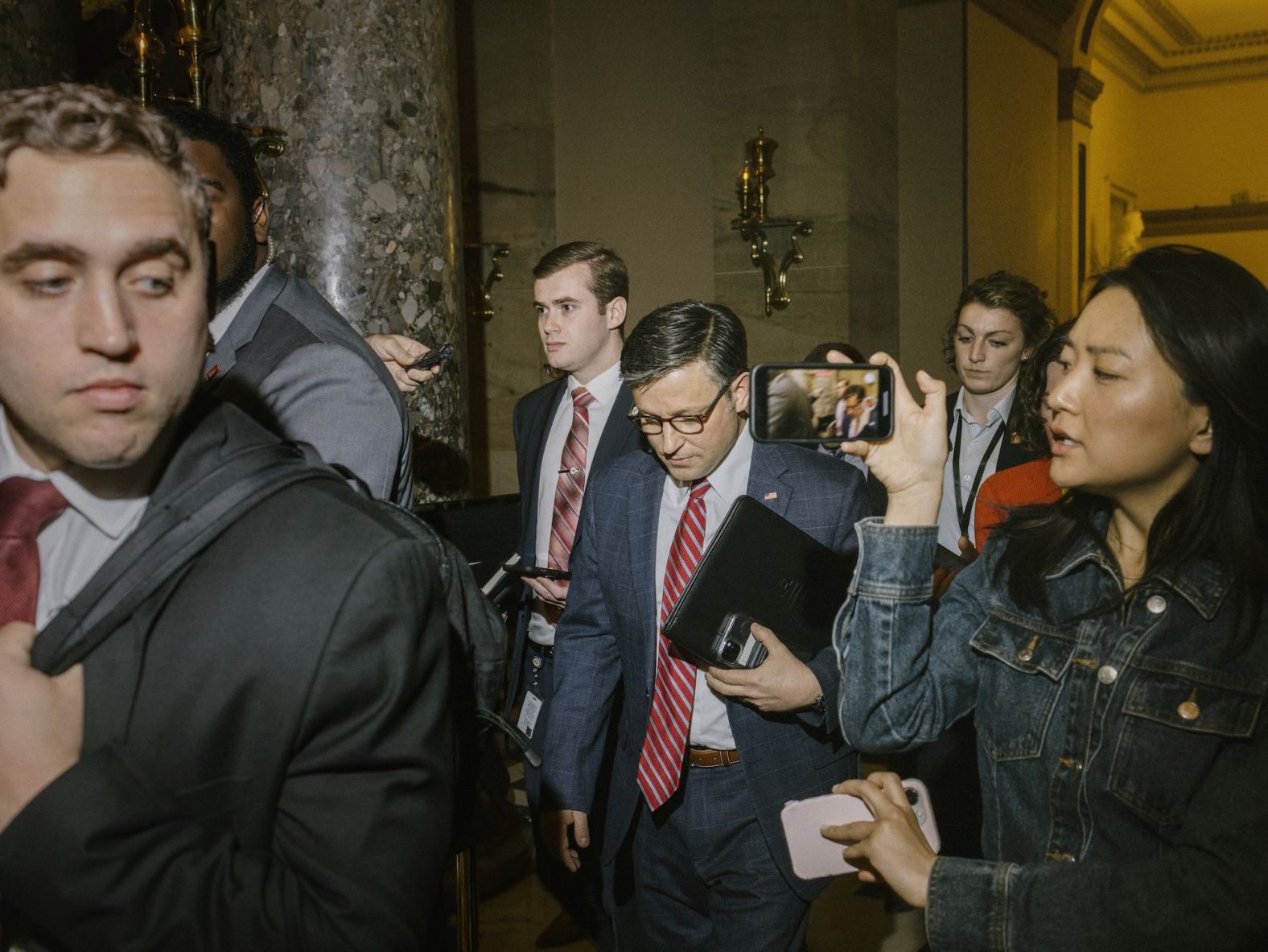 House Speaker Mike Johnson speaks to reporters as he walks back to his office at the Capitol in Washington, DC, on Friday, April 12. <a href="https://www.cnn.com/2024/04/17/politics/mike-johnson-ukraine-aid/index.html" target="_blank">Johnson announced Wednesday</a> he is sticking with his plan to put a series of foreign aid bills on the floor, including funding for Ukraine, after facing significant pressure from hardliners.