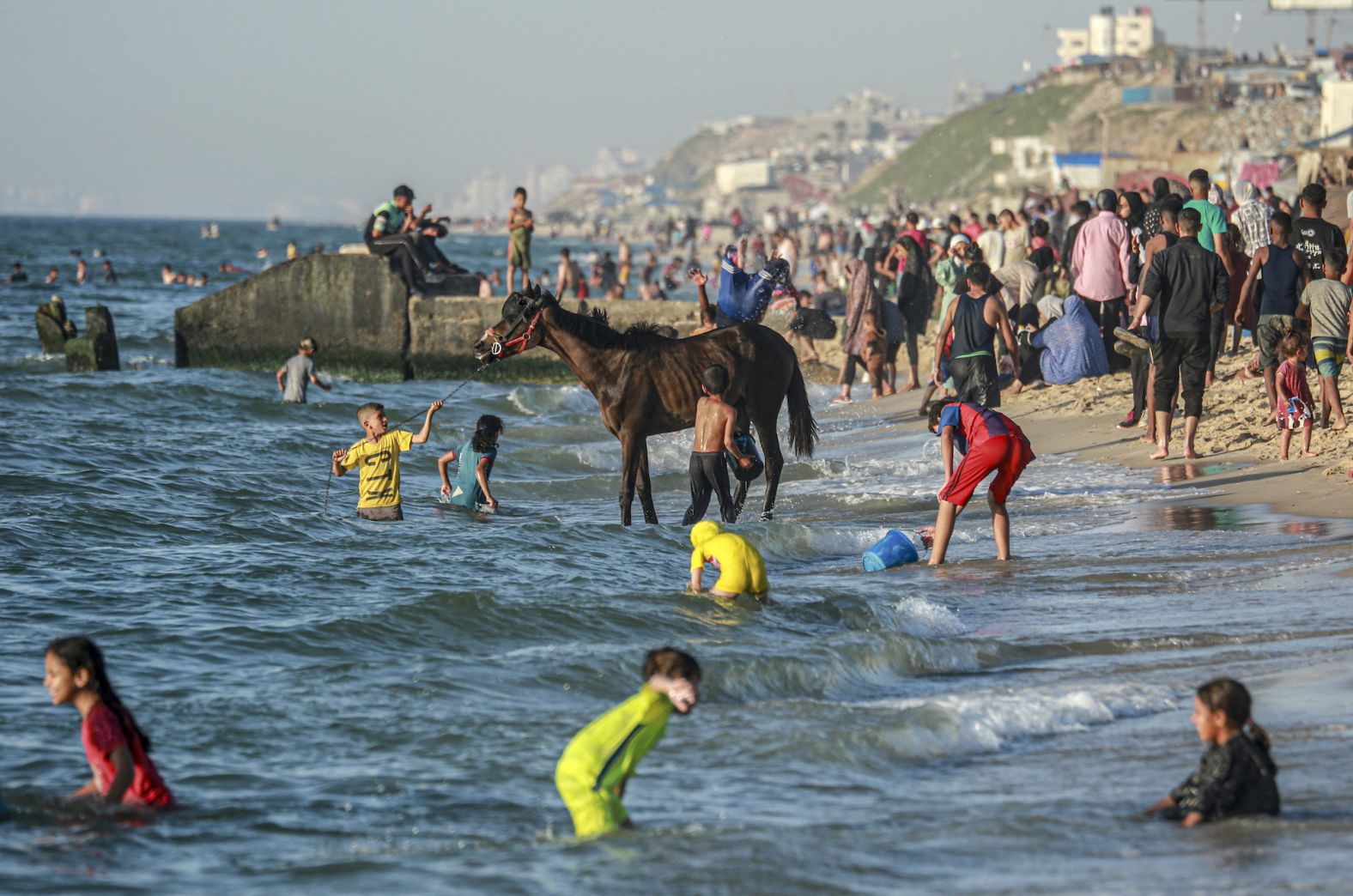 Palestinians gather on the beach in Deir al-Balah, Gaza, on Wednesday, April 17.