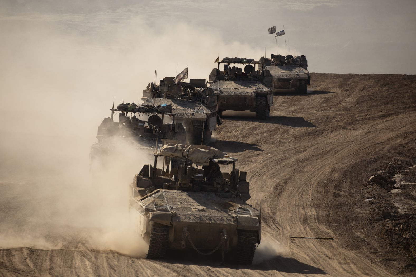 Israeli armored personnel carriers move along the Israel-Gaza border after leaving Gaza on Wednesday, April 17.