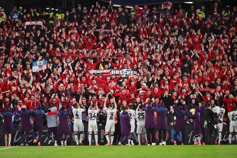 Fans of Bayer Leverkusen celebrate with the players following the side's qualification for the semifinal stage in the Europa League after quarterfinal second-leg match against West Ham United.