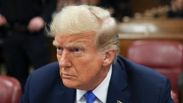 Former President Donald Trump looks on at Manhattan Criminal Court during his trial for allegedly covering up hush money payments linked to extramarital affairs in New York on April 22, 2024. 