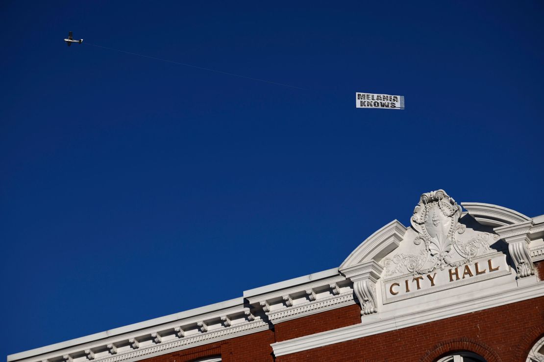 An airplane pulls a sign reading "Melania knows" over the Rochester Opera House ahead of a campaign rally with Republican presidential candidate and former President Donald Trump in Rochester, New Hampshire on January 21, 2024.