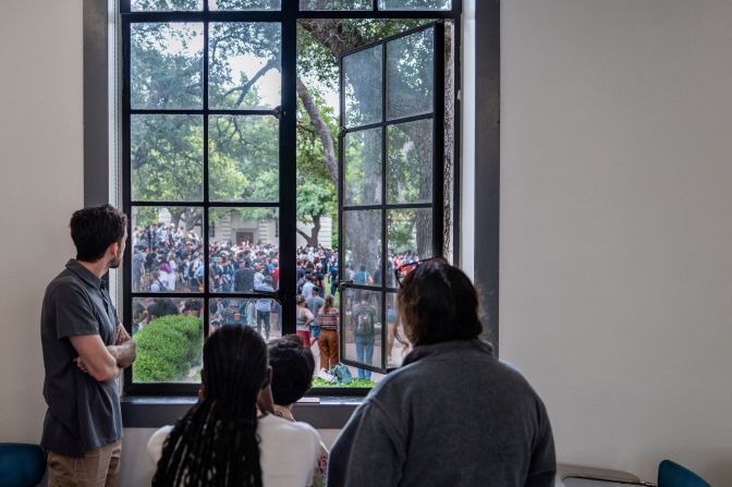Students at the University of Texas at Austin watch a protest from a classroom window on April 24.