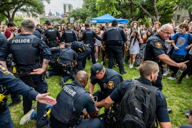 Students are arrested during the protest in Austin on April 24. <a href="index.php?page=&url=https%3A%2F%2Fwww.cnn.com%2Fbusiness%2Flive-news%2Fcolumbia-usc-university-protests-04-25-24%2Fh_fe6a015b9b48e0c63141f63de83c9726" target="_blank">There were dozens of arrests</a>. University police had warned students in an email that they faced more arrests if they didn't disperse from the site.