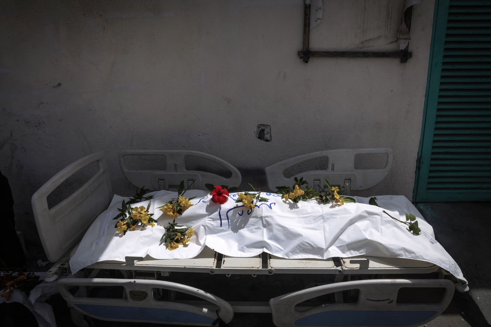 A body unearthed at Nasser Hospital is set on a stretcher and covered with flowers before being buried in Khan Younis, Gaza, on Tuesday, April 23. <a href="index.php?page=&url=https%3A%2F%2Fwww.cnn.com%2F2024%2F04%2F25%2Fmiddleeast%2Fgaza-400-bodies-mass-grave-hospital-intl%2Findex.html" target="_blank">Nearly 400 bodies have been found in mass graves at the hospital</a> following Israeli troops' withdrawal from the area earlier this month, the Palestinian Civil Defense in Gaza said on Thursday. The Israel Defense Forces has said any suggestion that it buried Palestinian bodies in mass graves was false, and that a grave at the Nasser complex was dug by Palestinians in Gaza some months ago.