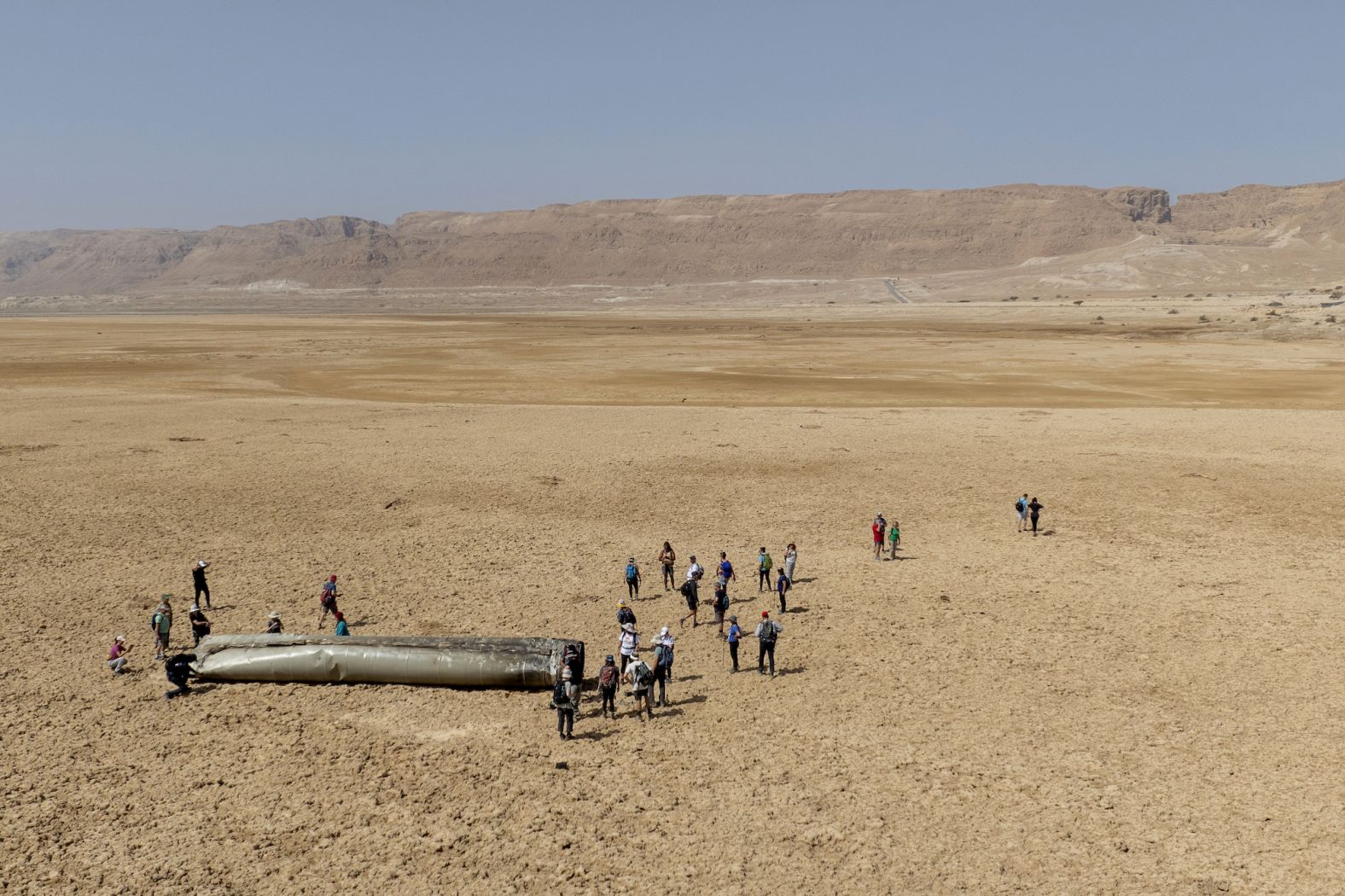 People gather around a piece of a ballistic missile near the Dead Sea in Israel on Saturday, April 20. Almost all the ballistic missiles and drones Iran launched at Israel in <a href="https://www.cnn.com/2024/04/14/middleeast/israel-air-missile-defense-iran-attack-intl-hnk-ml/index.html" target="_blank">an unprecedented attack</a> this month were intercepted and failed to meet their mark, according to Israeli and American officials. The attack followed an Israeli strike on an Iranian diplomatic complex in Syria.