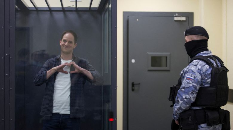 Wall Street Journal reporter Evan Gershkovich, who is in custody on espionage charges, makes a heart-shaped gesture inside an enclosure for defendants before a court hearing in Moscow, Russia, April 23, 2024. REUTERS/Tatyana Makeyeva     TPX IMAGES OF THE DAY