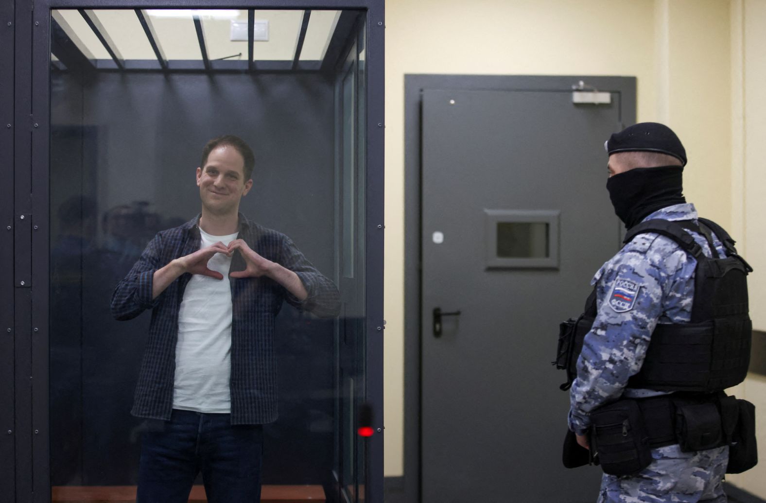 Wall Street Journal reporter Evan Gershkovich makes a heart-shaped gesture inside a defendants cage before a court hearing in Moscow on Tuesday, April 23. <a href="index.php?page=&url=https%3A%2F%2Fwww.cnn.com%2F2024%2F03%2F29%2Fpolitics%2Fevan-gershkovich-one-year-russian-detention%2Findex.html" target="_blank">Gershkovich has spent over a year in Russian detention</a>. He is being held on espionage charges, which he and his employer vehemently contest.