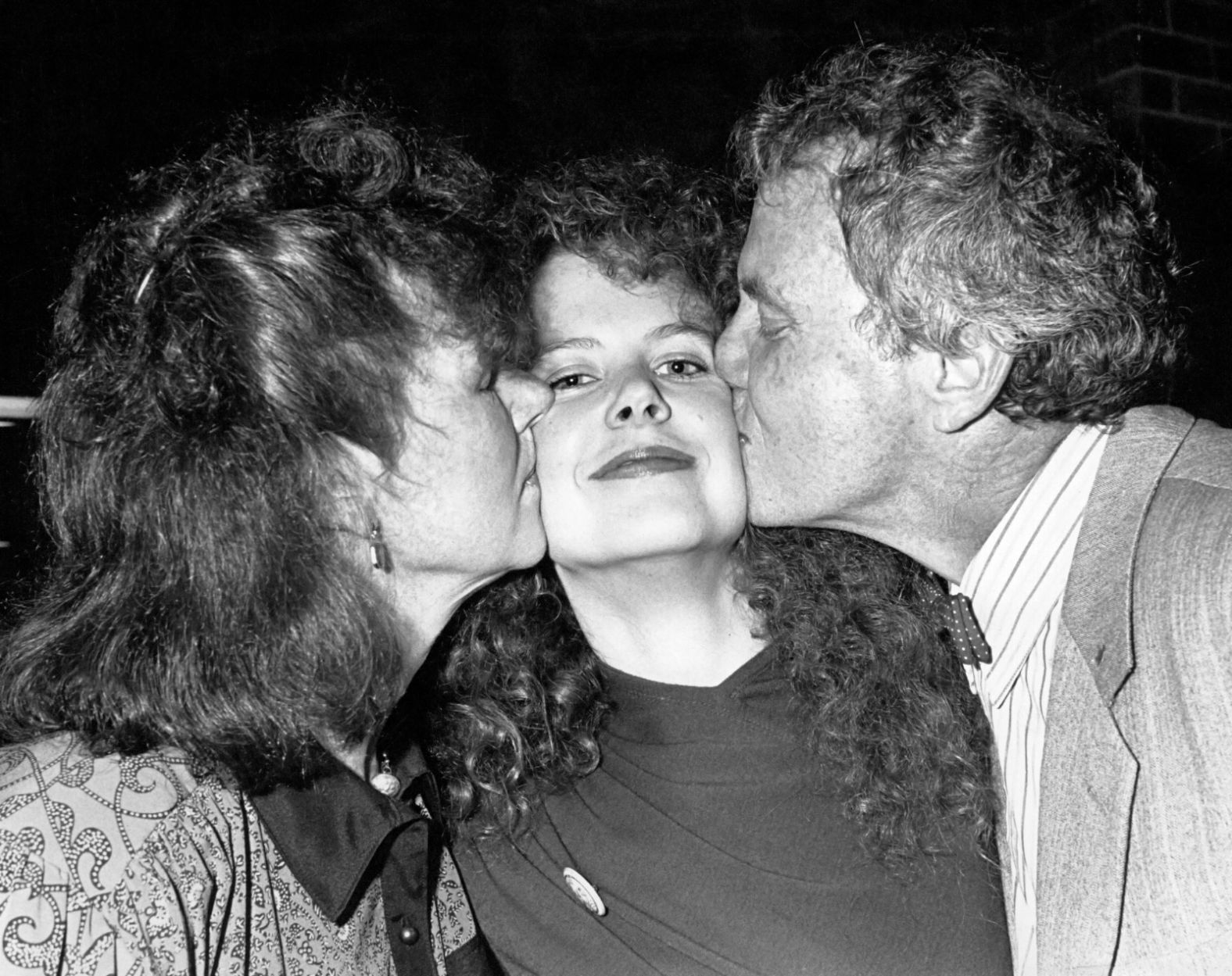Kidman receives kisses from her parents, Janelle and Antony, in 1988.