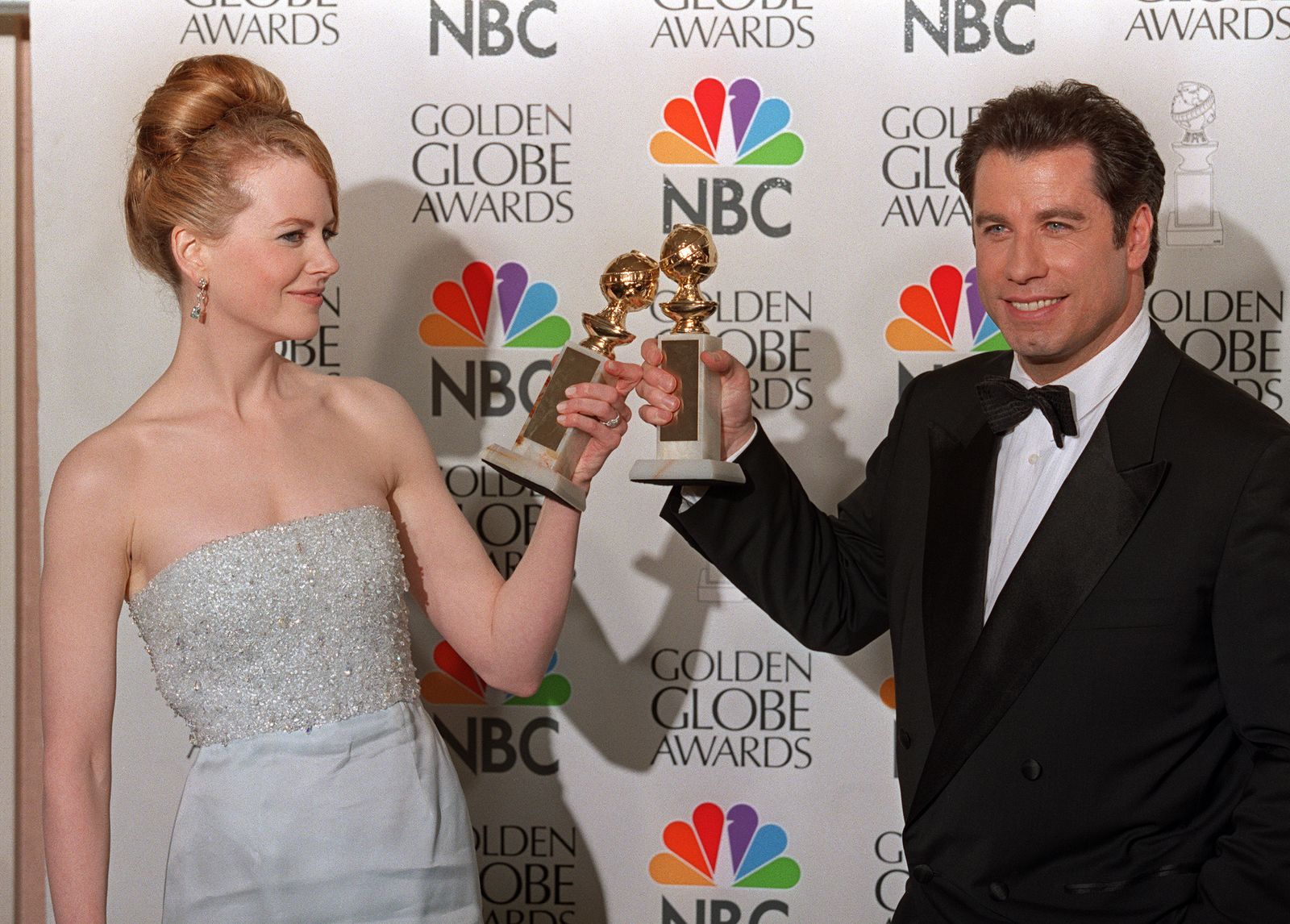 Kidman and John Travolta toast with the Golden Globe Awards they won in 1998.