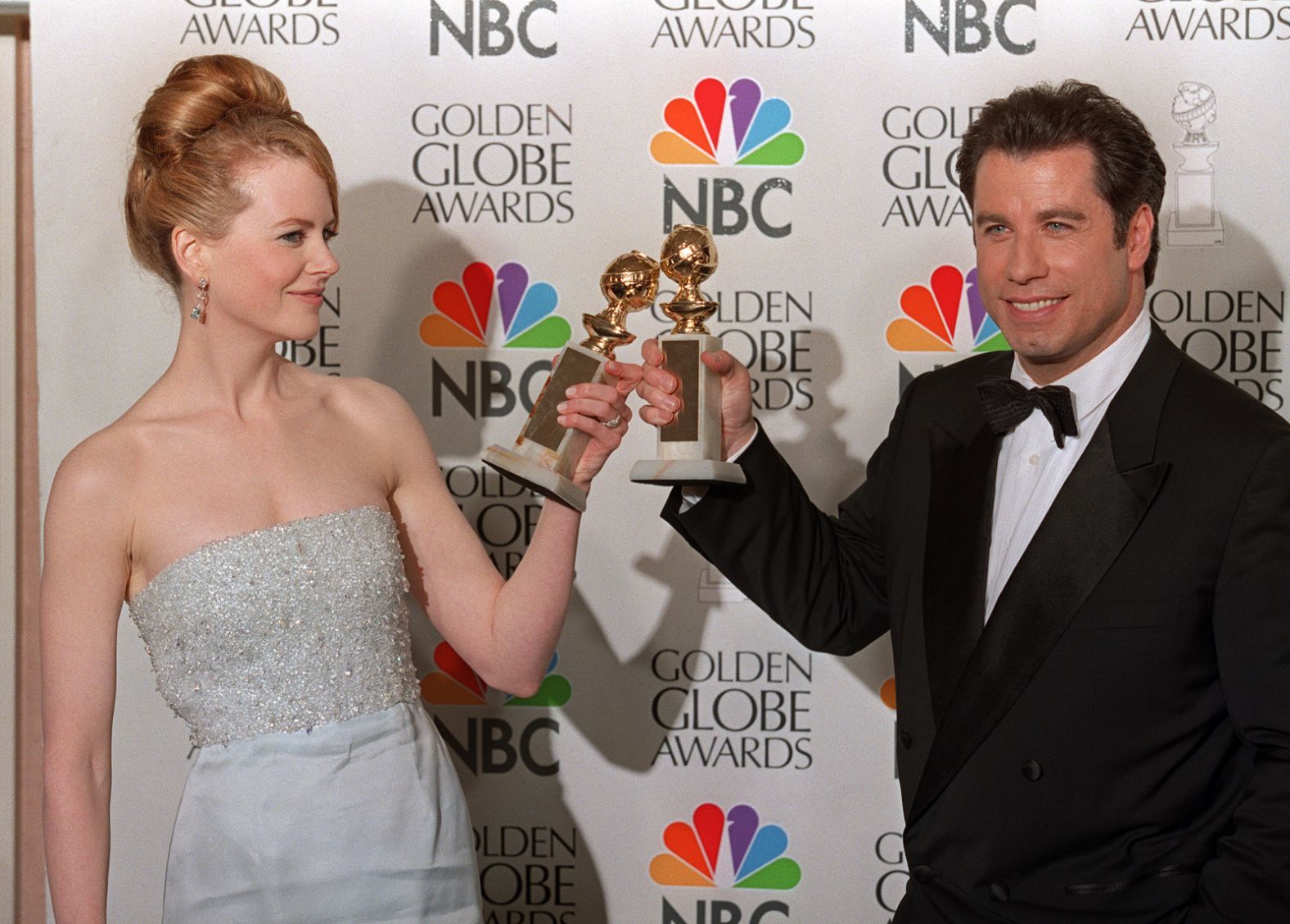 Kidman and John Travolta toast with the Golden Globe Awards they won in 1998. She won best actress in a comedy motion picture ("To Die For").