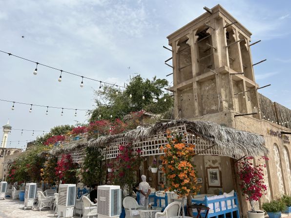 The district features traditional Persian architecture, such as wind towers, which capture the sea breeze to cool homes naturally — seen here at The Arabic Teahouse (which also uses fans to help outdoor diners beat the heat), a favorite stop in Al Fahidi for visitors to sample delicious regional dishes.