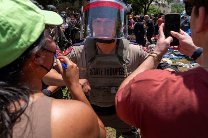 Pro-Palestinian protesters confront a Texas state trooper at the University of Texas in Austin on April 29.