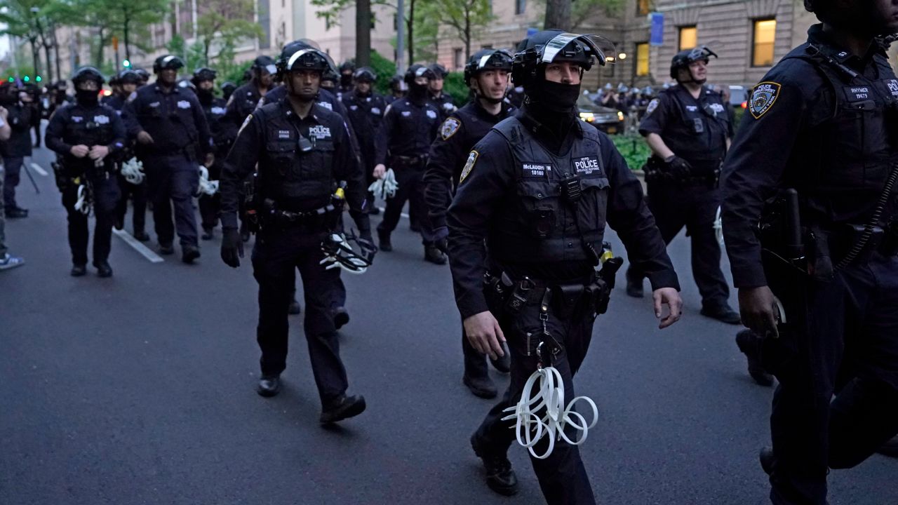 NYPD officers arrive near Columbia University where pro-Palestinian students are barricaded inside a building and have set up an encampment, in New York City on April 30, 2024. Columbia University normally teems with students, but a "Free Palestine" banner now hangs from a building where young protesters have barricaded themselves and the few wandering through campus generally appear tense. Students here were among the first to embrace the pro-Palestinian campus encampment movement, which has spread to a number of universities across the United States. (Photo by TIMOTHY A. CLARY / AFP) (Photo by TIMOTHY A. CLARY/AFP via Getty Images)