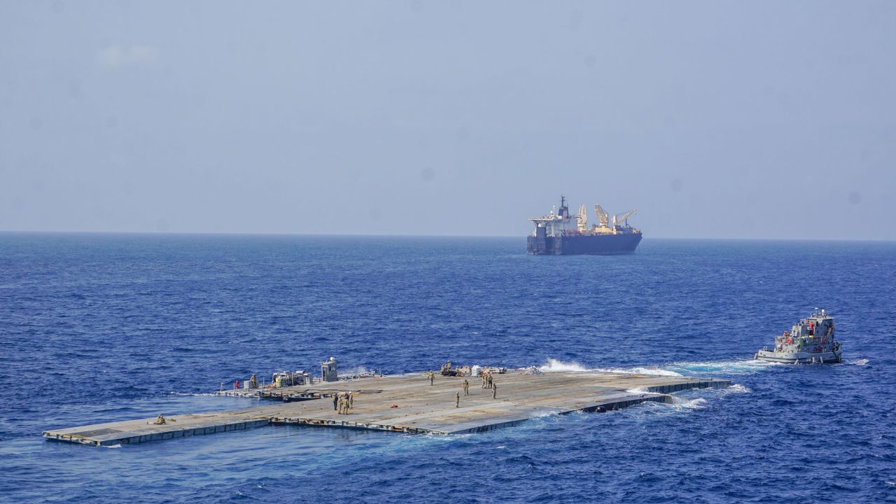 The Roll-On, Roll-Off Distribution Facility, or floating pier, is pulled by an Army tug boat during Operation Neptune Solace off the shore of Gaza on May 1, 2024. The temporary pier will assist the United States Agency for International Development in the delivery of humanitarian aid to the people of Gaza.