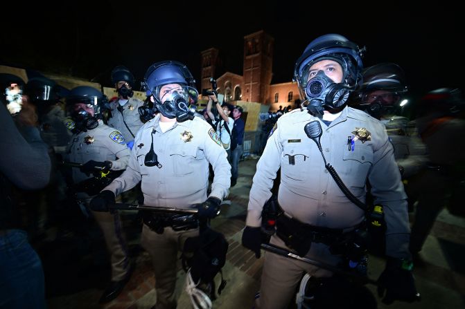 Police officers stand guard after clashes erupted on the campus of UCLA.
