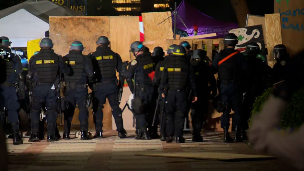 Watch police remove pieces of barricade at UCLA protest encampment | CNN